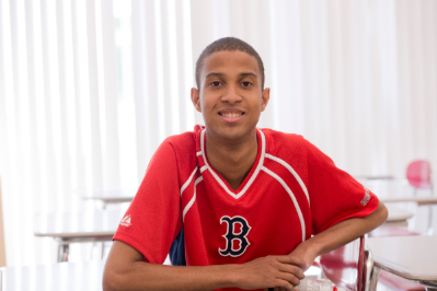 Male student in classroom with red shirt